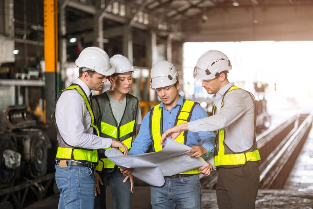group of industry people engineer brainstorm team builder architect and technician talking consulting together in site building for renovation planning with floor plan together.